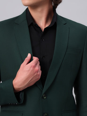 Close view of smooth viscose fabric in green blazer