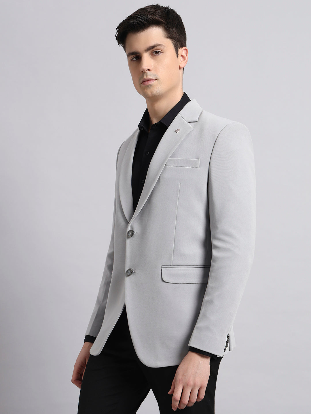 Tailored lapel and structured design of grey men’s blazer