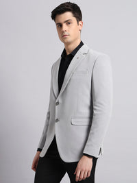 Tailored lapel and structured design of grey men’s blazer