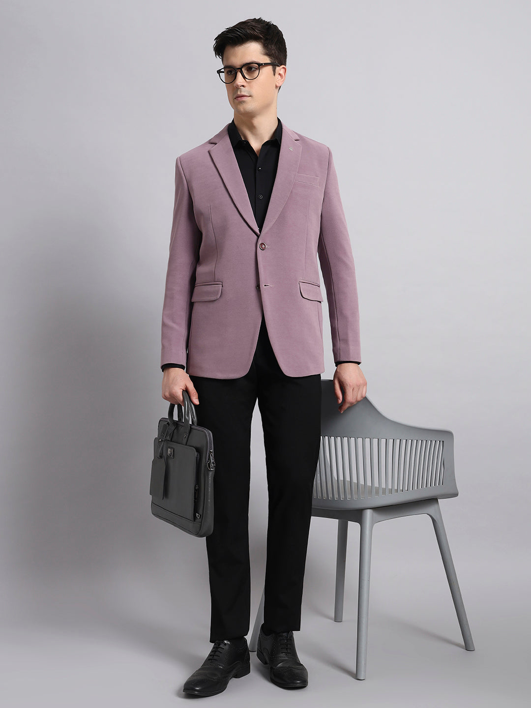 Statement look with pink stretchable blazer in studio shoot