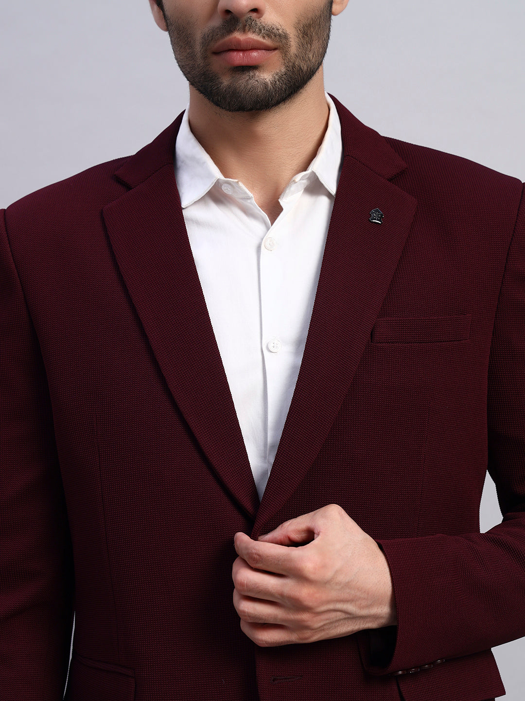 Close view of premium stretch fabric in wine blazer